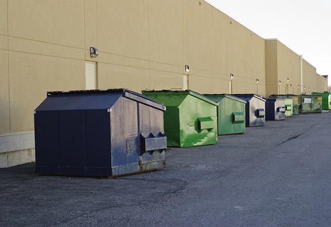 metal waste containers sit at a busy construction site in Auburn